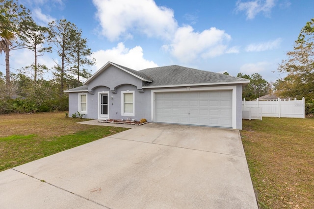 single story home with a garage and a front lawn