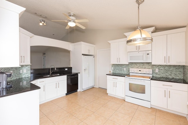 kitchen with sink, vaulted ceiling, hanging light fixtures, white appliances, and white cabinets