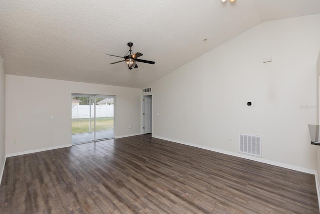 empty room with ceiling fan, lofted ceiling, dark hardwood / wood-style floors, and a textured ceiling