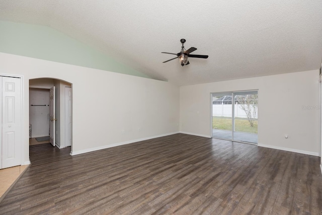 unfurnished room featuring lofted ceiling, a textured ceiling, dark hardwood / wood-style floors, and ceiling fan