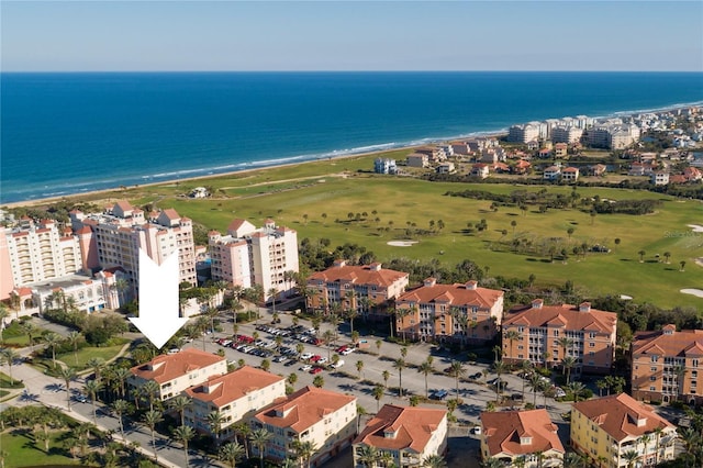 birds eye view of property with a beach view and a water view