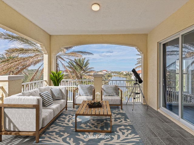 view of patio with an outdoor living space and a balcony