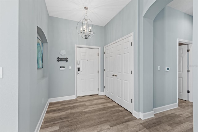 foyer featuring an inviting chandelier and hardwood / wood-style floors