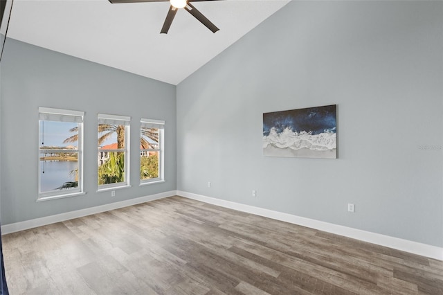 empty room featuring high vaulted ceiling, hardwood / wood-style floors, and ceiling fan