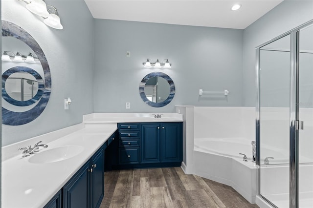 bathroom with vanity, hardwood / wood-style floors, and plus walk in shower