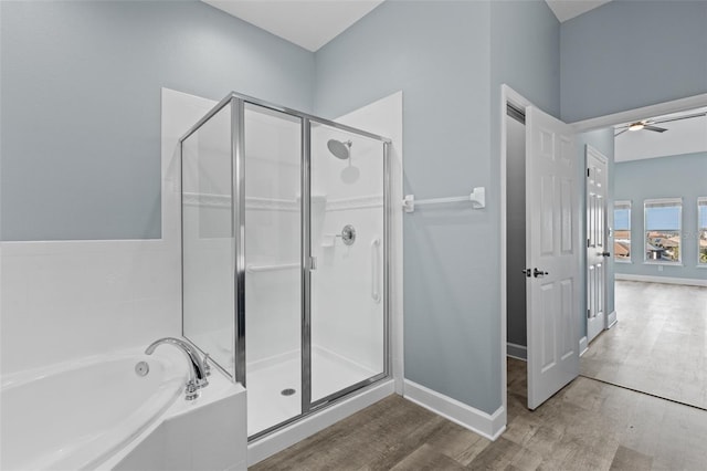 bathroom featuring independent shower and bath, hardwood / wood-style floors, and ceiling fan