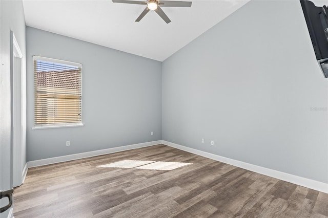 empty room featuring ceiling fan, vaulted ceiling, and light hardwood / wood-style flooring