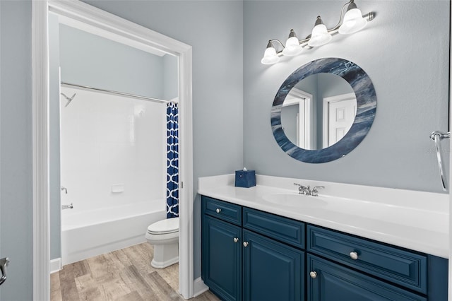 full bathroom with vanity, toilet, hardwood / wood-style floors, and shower / bath combo with shower curtain