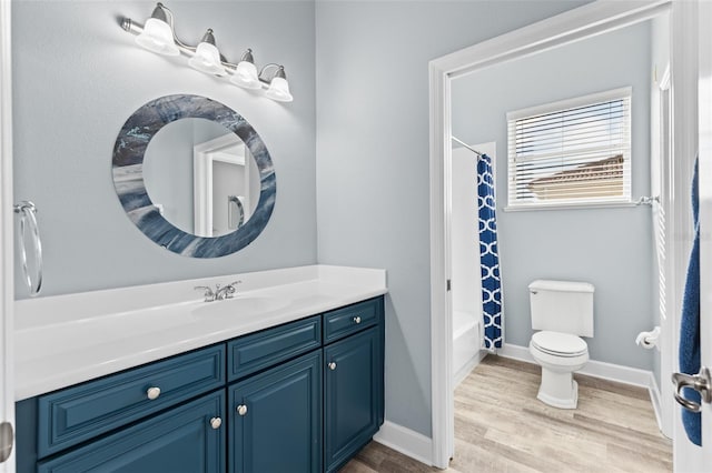 full bathroom featuring vanity, hardwood / wood-style flooring, toilet, and shower / bath combo with shower curtain