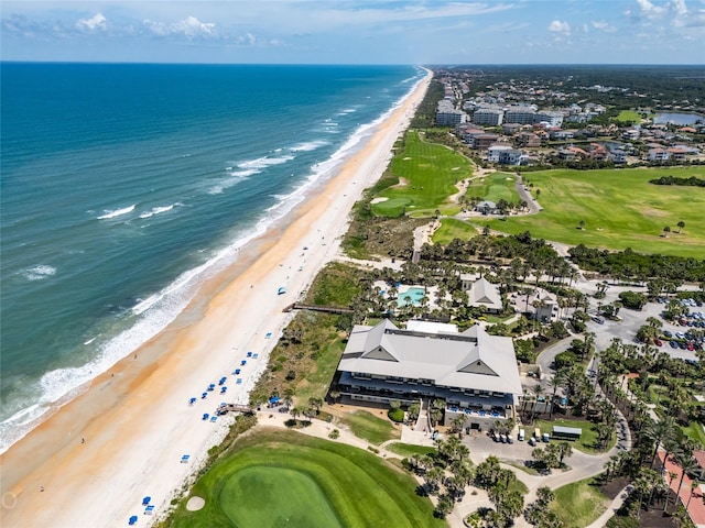 birds eye view of property with a water view and a beach view