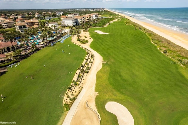 birds eye view of property with a water view and a view of the beach