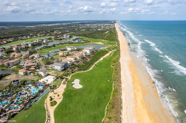 birds eye view of property featuring a water view and a beach view