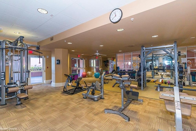 gym with ceiling fan and carpet