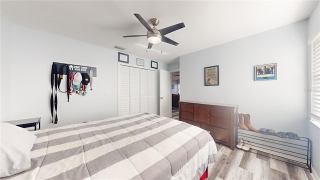 bedroom with ceiling fan and light hardwood / wood-style floors