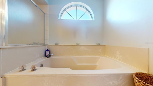 bathroom with a tub to relax in