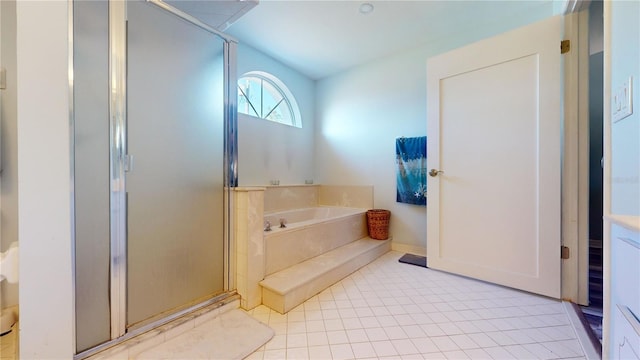 bathroom featuring tile patterned floors and separate shower and tub