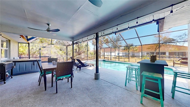 view of pool with a patio, a lanai, an outdoor bar, and ceiling fan