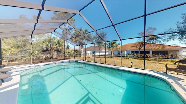 view of swimming pool featuring a lanai