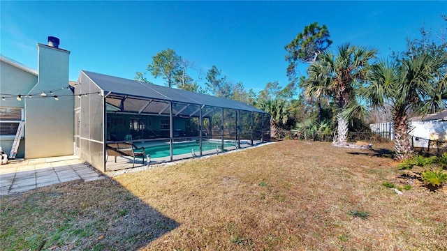 view of yard with a patio area and glass enclosure