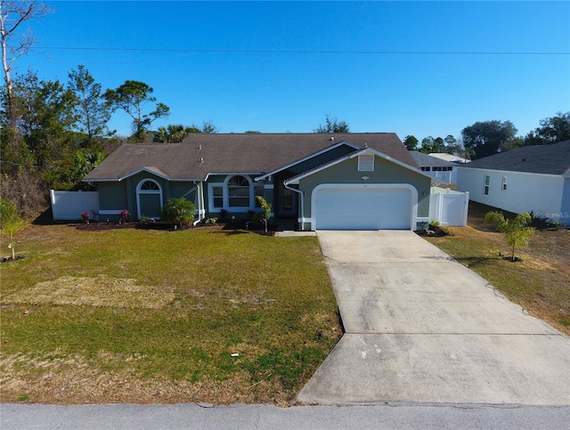 single story home featuring a garage and a front yard