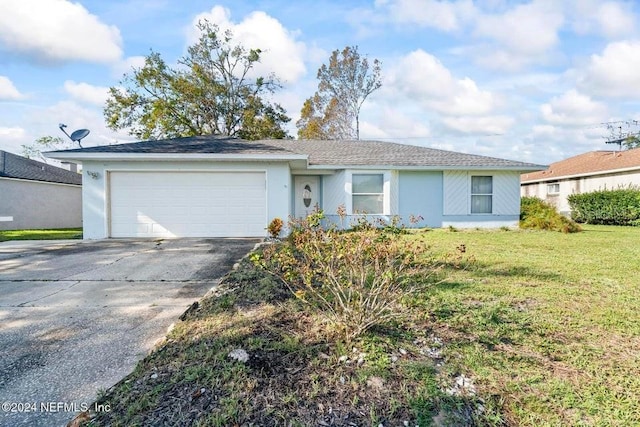 ranch-style house featuring a garage and a front lawn