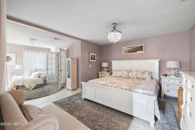 bedroom with light tile patterned floors and a textured ceiling