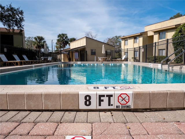 pool featuring a patio and fence