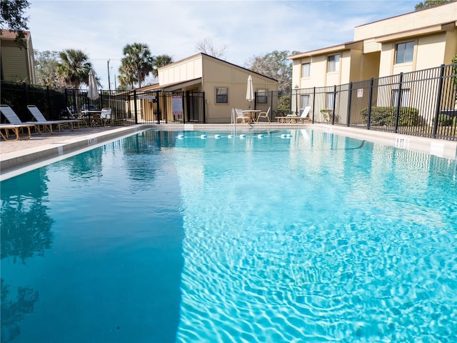 community pool featuring a patio and fence