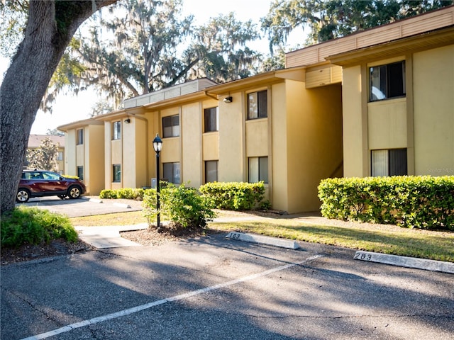 view of property featuring uncovered parking