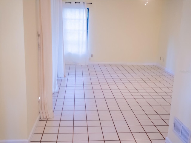 empty room with light tile patterned flooring and visible vents