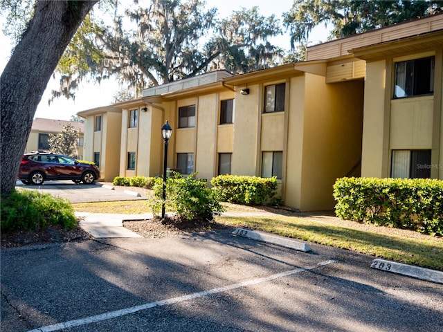 view of property featuring uncovered parking