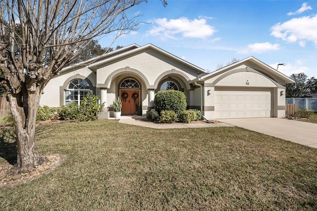 ranch-style home with a garage and a front yard