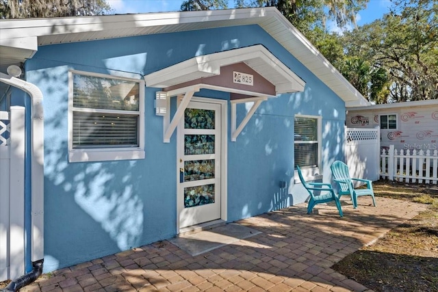 entrance to property with a patio