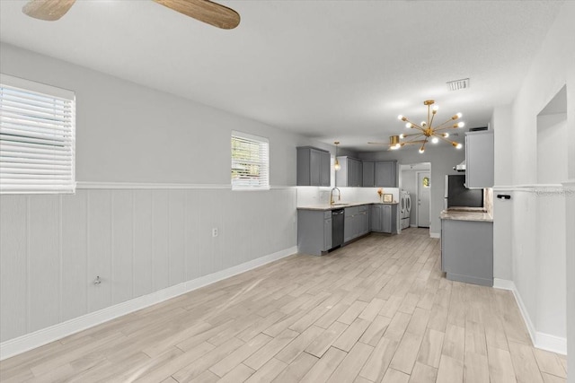 kitchen featuring gray cabinets, refrigerator, dishwasher, sink, and light wood-type flooring