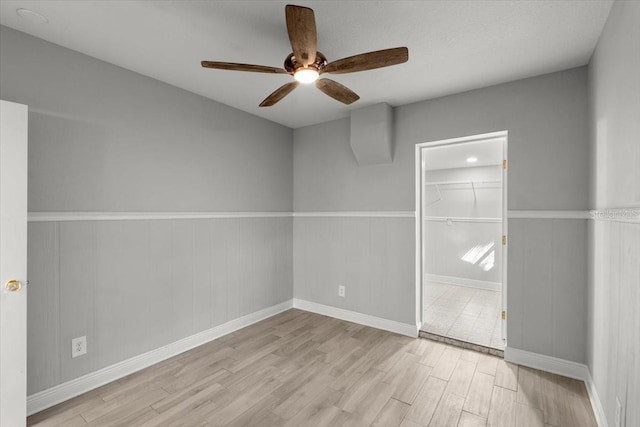 spare room featuring ceiling fan and light hardwood / wood-style floors