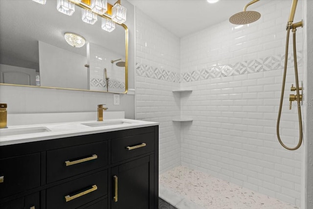 bathroom with vanity and a tile shower