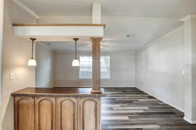 interior space featuring crown molding, dark wood-type flooring, and ornate columns