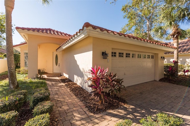 mediterranean / spanish home featuring a garage