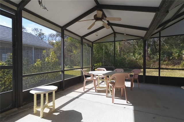 sunroom featuring lofted ceiling with beams and ceiling fan