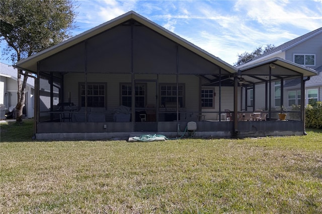 back of property featuring a yard and a sunroom