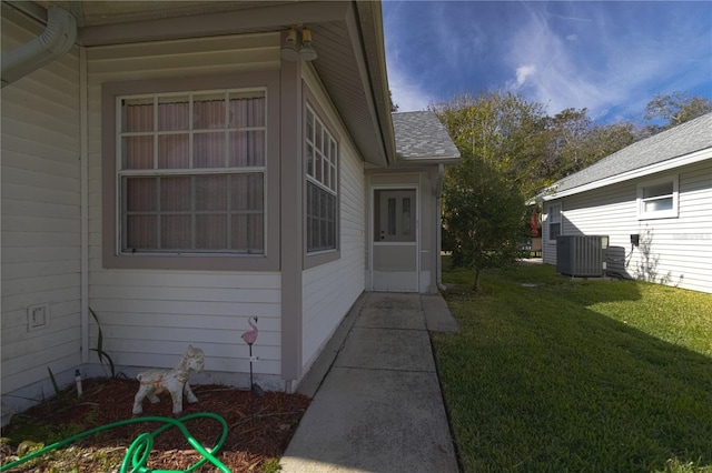 view of property exterior with cooling unit and a yard