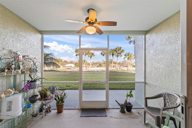 sunroom / solarium featuring ceiling fan