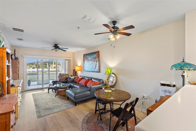 living room featuring ceiling fan and light wood-type flooring