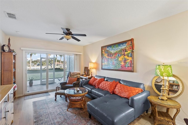 living room featuring hardwood / wood-style flooring and ceiling fan