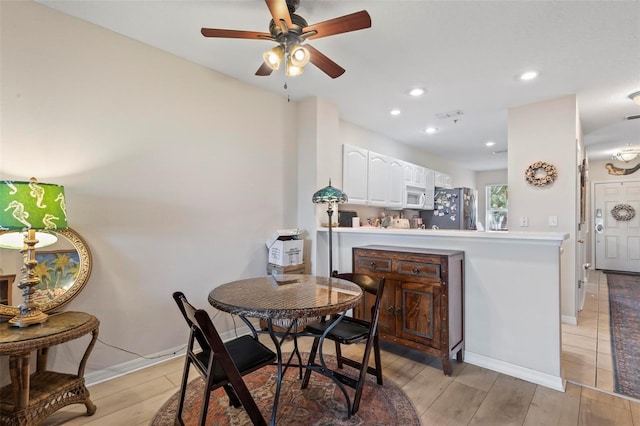 dining space featuring ceiling fan and light hardwood / wood-style floors