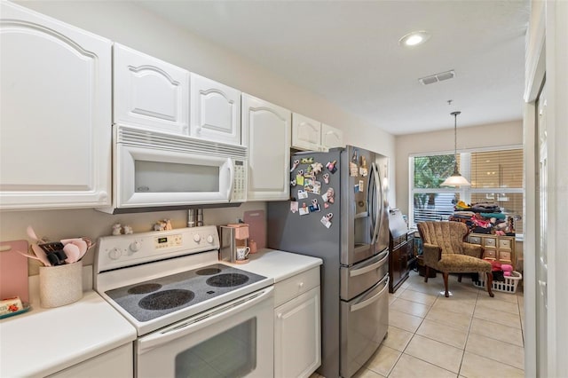 kitchen featuring white cabinetry, pendant lighting, white appliances, and light tile patterned floors