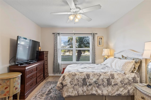 bedroom with ceiling fan and light hardwood / wood-style floors