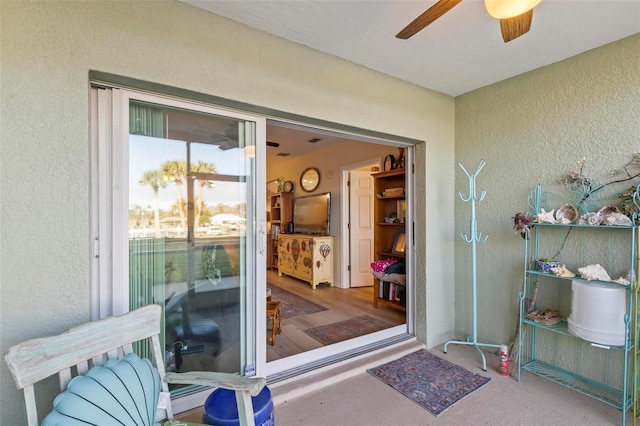 entrance to property featuring ceiling fan