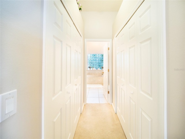 corridor with light colored carpet