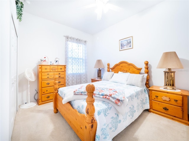 carpeted bedroom featuring ceiling fan and a closet